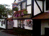 Front view of the Black Horse pub, showing typical flower baskets